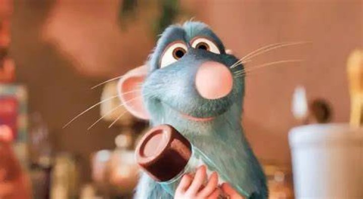 A character cooking with Remy in Disney Dreamlight Valley