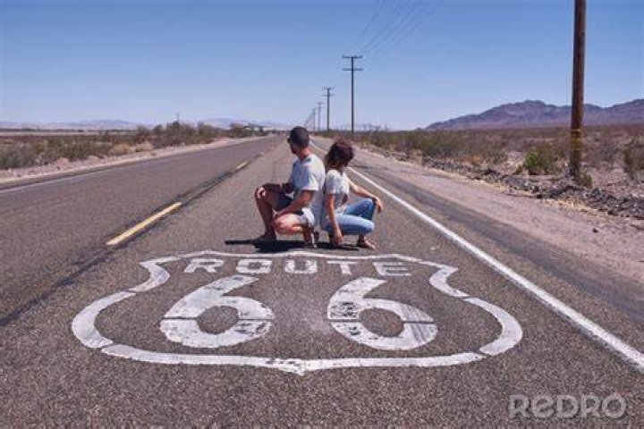 Ana crouching on Route 66 in Overwatch