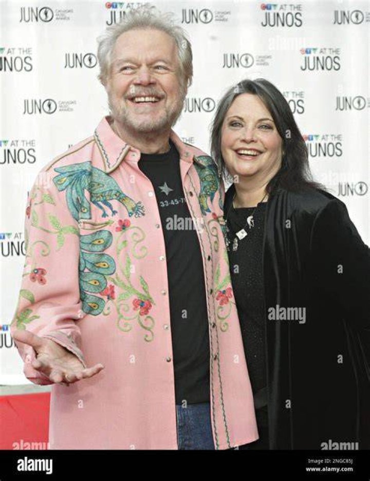 Burton Cummings and his wife Denise McCann laugh as they pose for