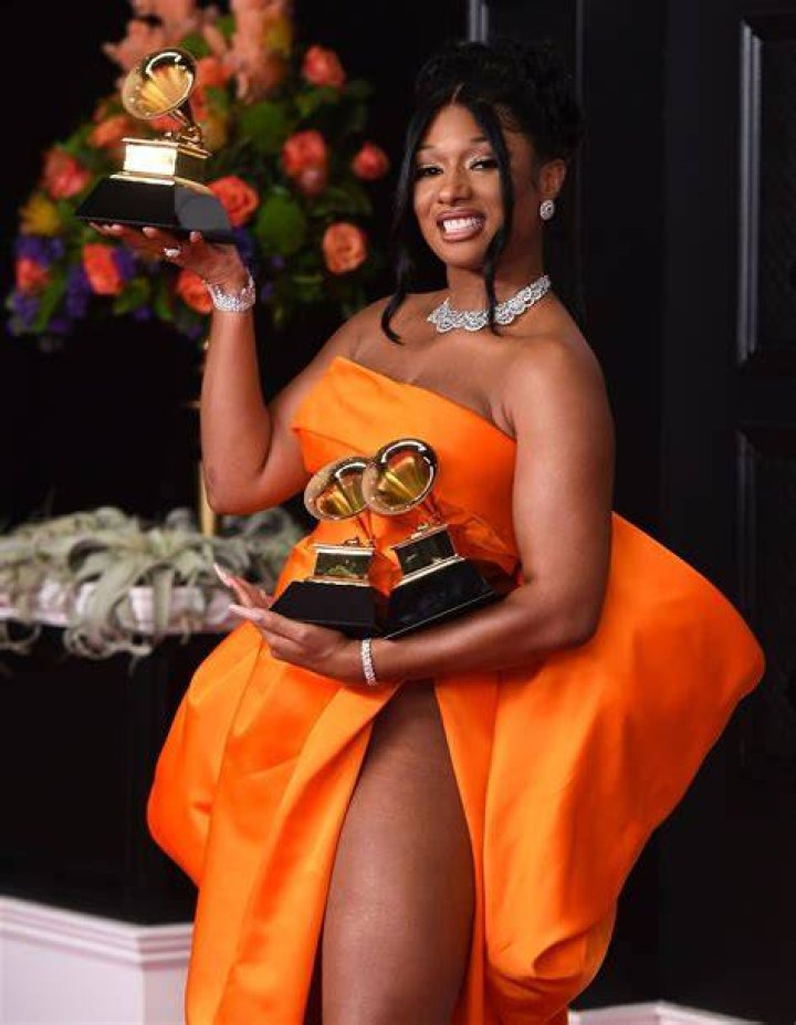 Megan Thee Stallion holds a drink with only her BUTT as boyfriend Pardi