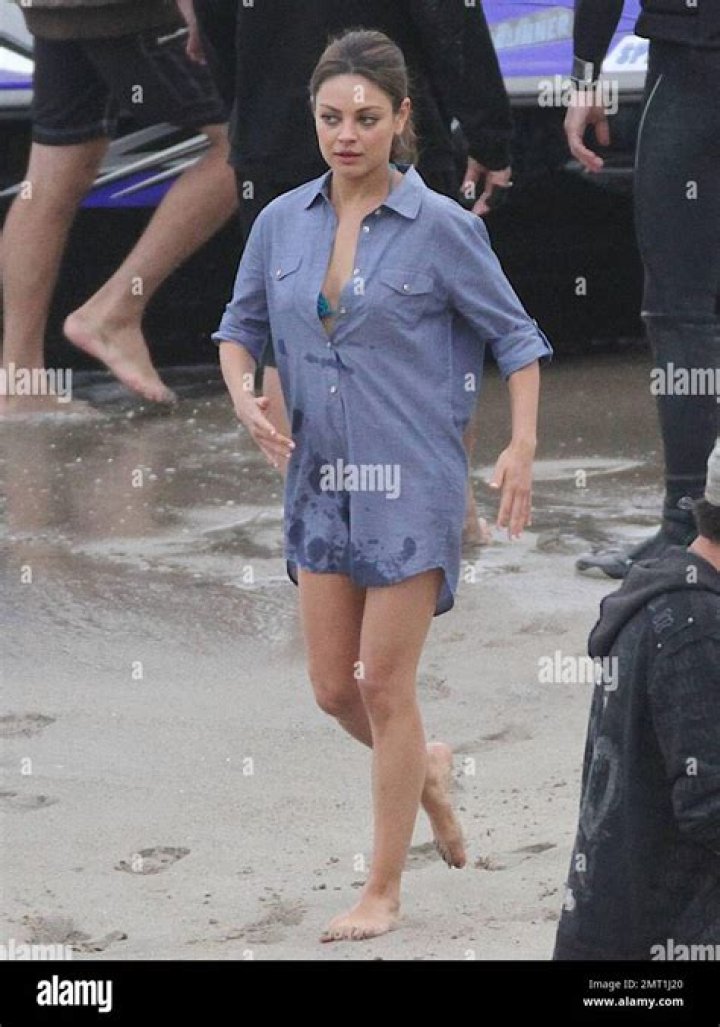 Mila Kunis slips on a Seventies style wedding dress to marry onscreen