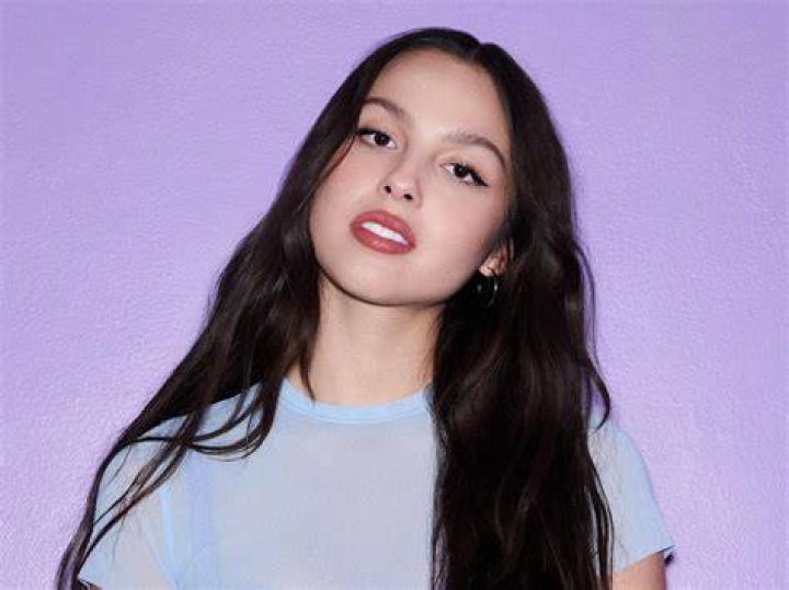 Olivia Rodrigo holding her Sour record