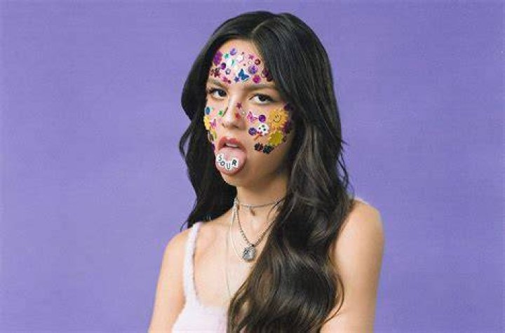 Olivia Rodrigo holds her album