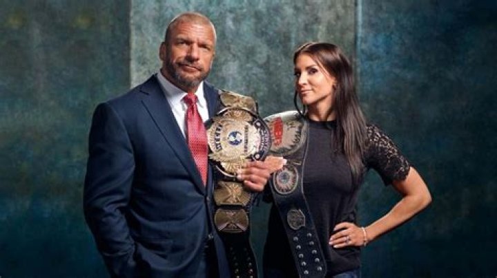 WWE Triple H & Stephanie McMahon present Brock Lesnar with the new WWE